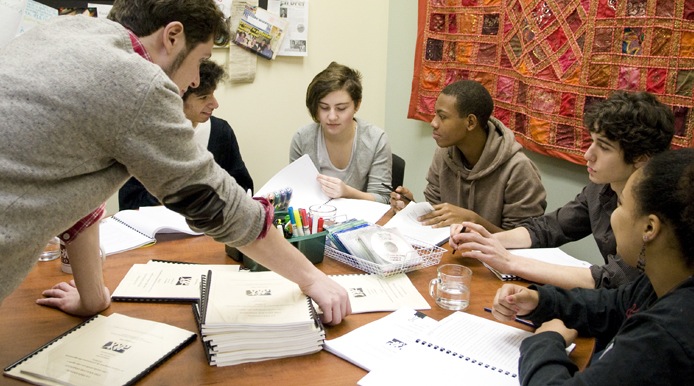 students learning and studying around a table