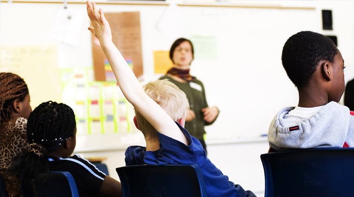 student with raised hand