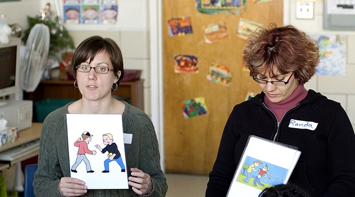 two people showing pictures of people