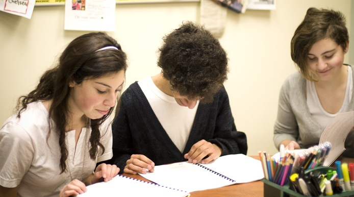 students reading paperwork booklet